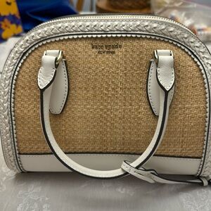 Kate spade white and straw crossbody bag with white leather strap as well.